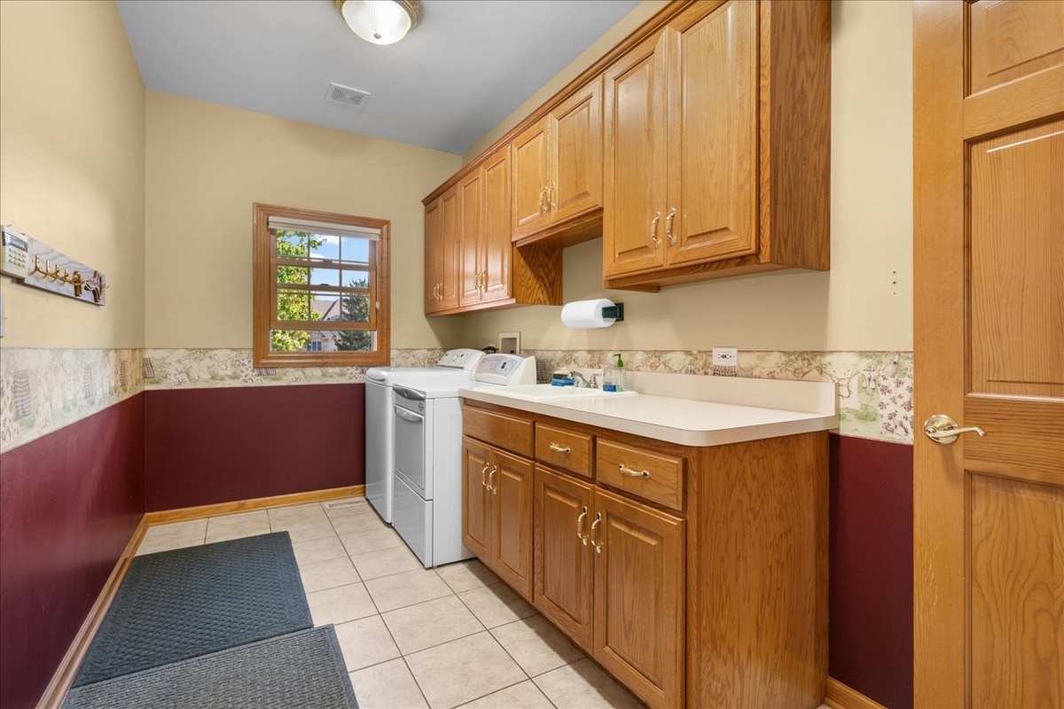 36W824 Red Gate Court St. Charles, IL 60175 - Photo 17 of 39 a kitchen with stainless steel appliances granite countertop a sink stove and cabinets