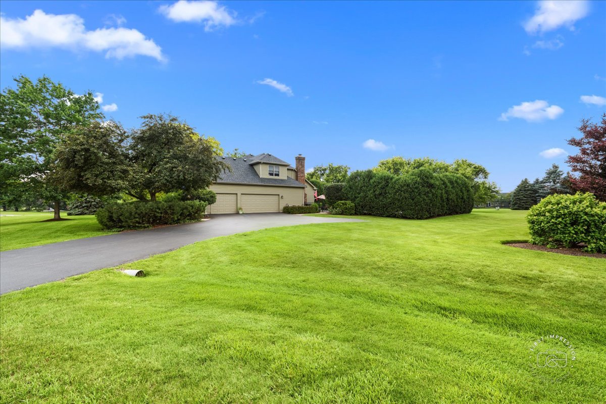 36W824 Red Gate Court St. Charles, IL 60175 - Photo 2 of 39 a view of a garden with a building in the background