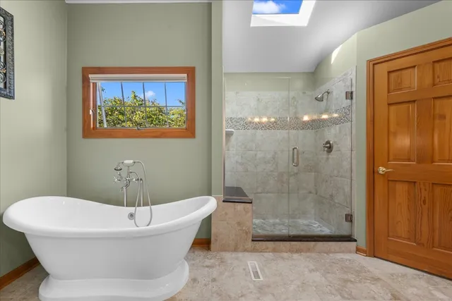 a bathroom with a bathtub and shower