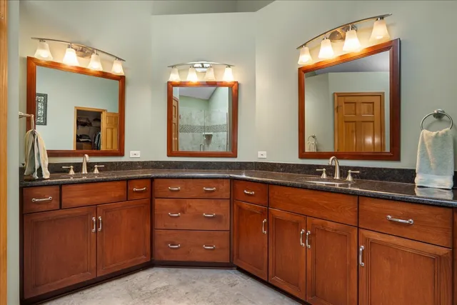 a bathroom with double vanity sink and a mirror