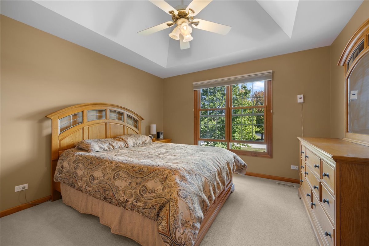 36W824 Red Gate Court St. Charles, IL 60175 - Photo 24 of 39 a bedroom with a bed and a chandelier