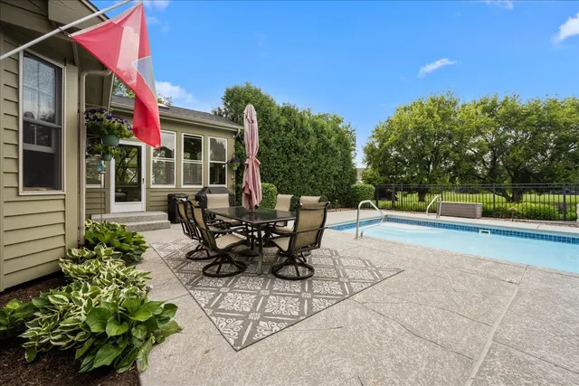 a view of a patio with table and chairs and potted plants