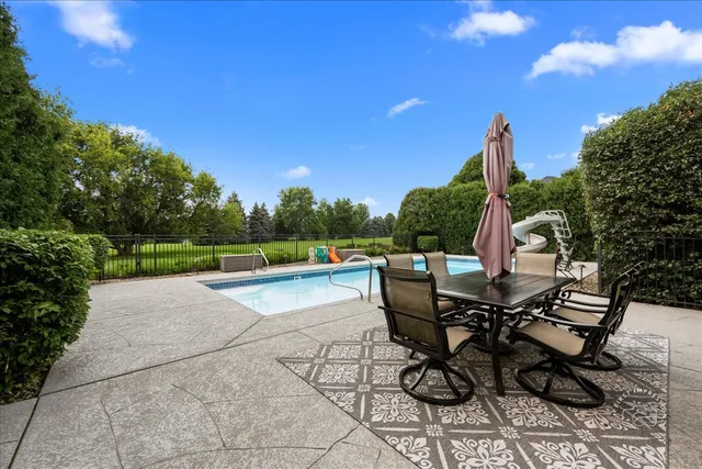a view of a patio with table and chairs and potted plants