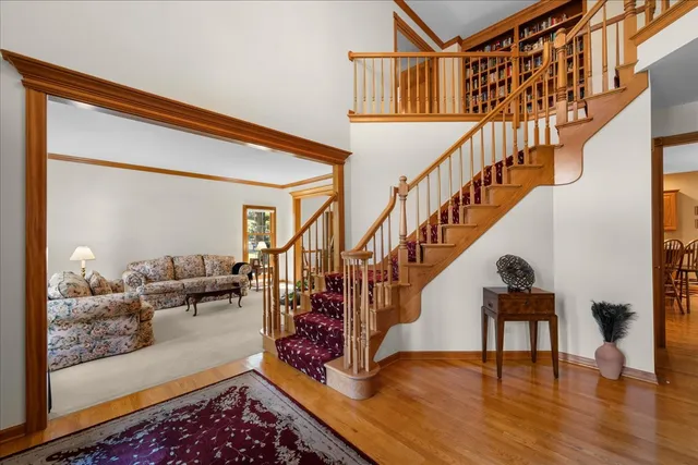 a view of entryway and hall with wooden floor