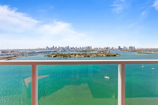 a view of a lake with houses in the background