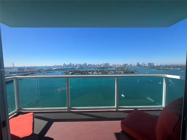a view of a two chairs in the middle of a lake