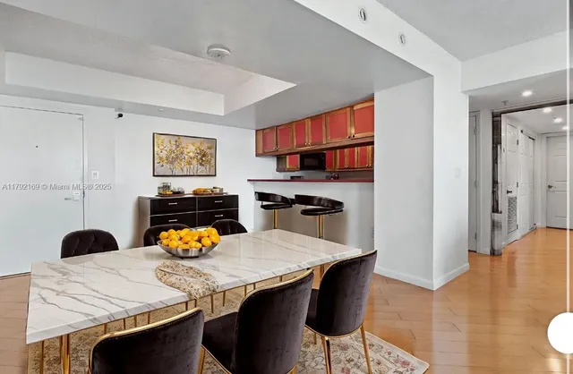 a kitchen with a table chairs and a refrigerator