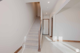 Stairs featuring recessed lighting and baseboards