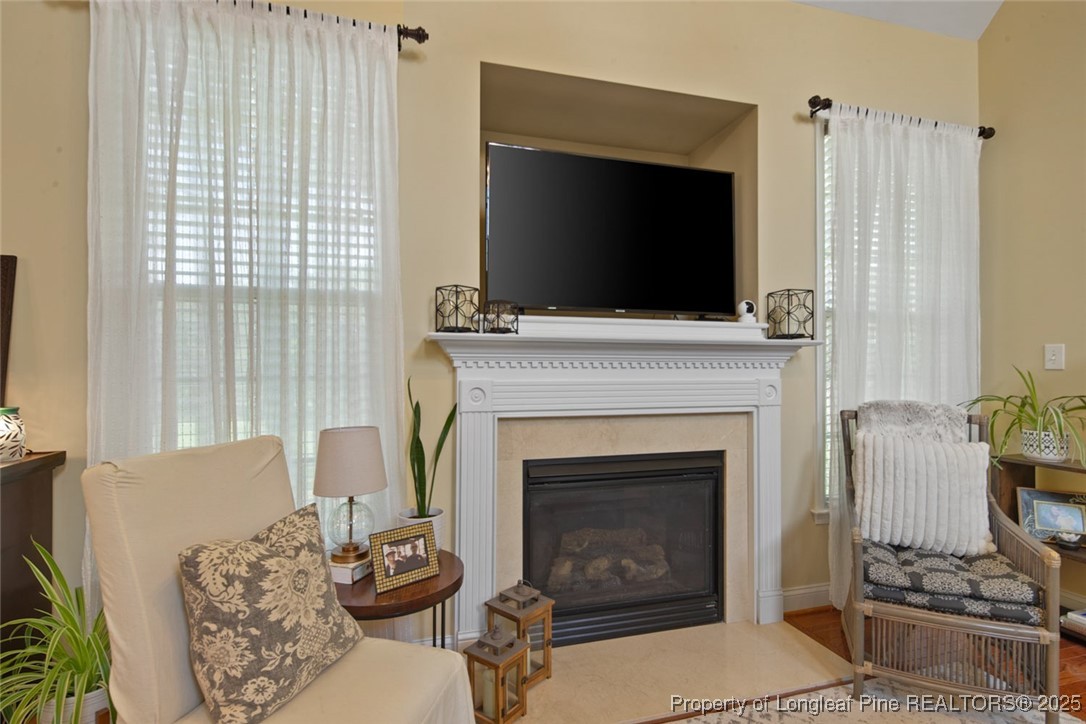 15 London Way Spring Lake, NC 28390 - Photo 13 of 46 a living room with furniture a flat screen tv and a fireplace