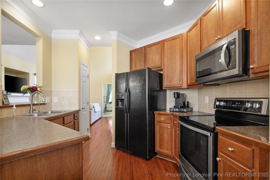 15 London Way Spring Lake, NC 28390 - Photo 20 of 46 a kitchen with stainless steel appliances granite countertop a refrigerator stove microwave and sink