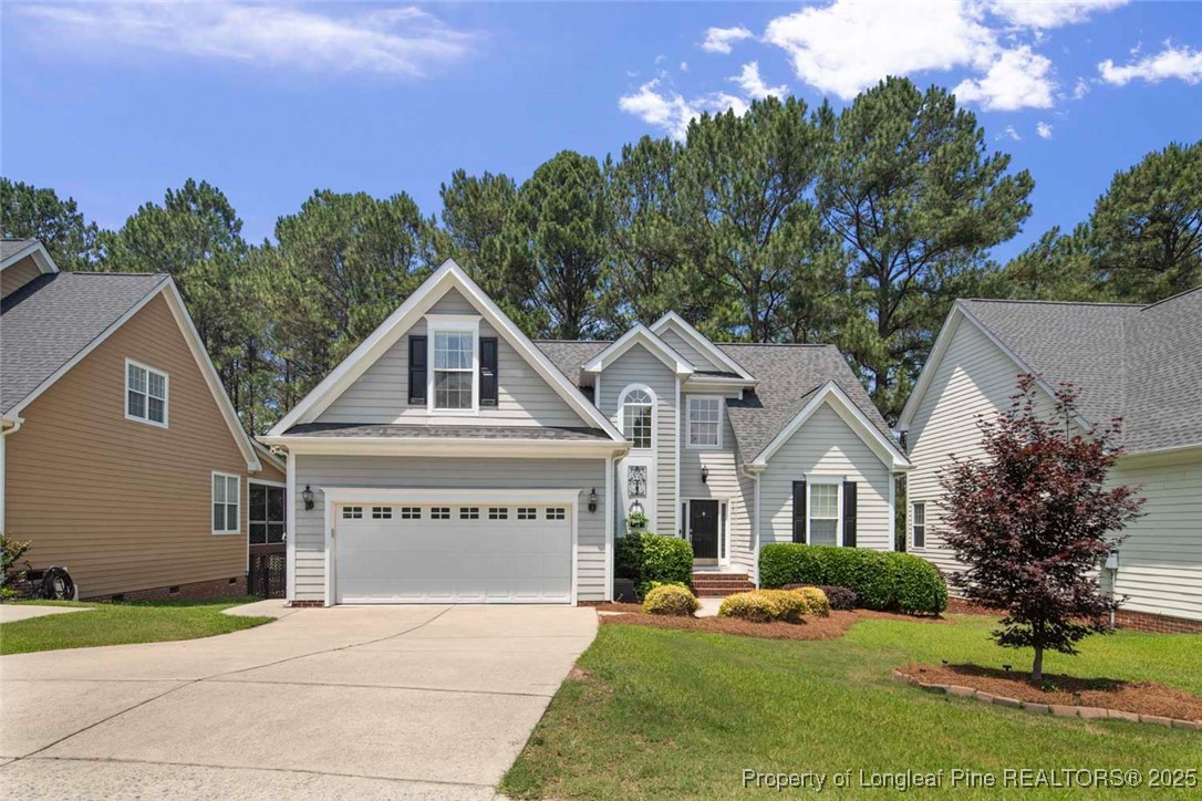 15 London Way Spring Lake, NC 28390 - Photo 2 of 46 a view of house with garden and tall tress