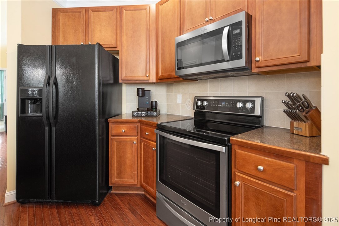 15 London Way Spring Lake, NC 28390 - Photo 21 of 46 a kitchen with stainless steel appliances granite countertop a refrigerator stove and microwave