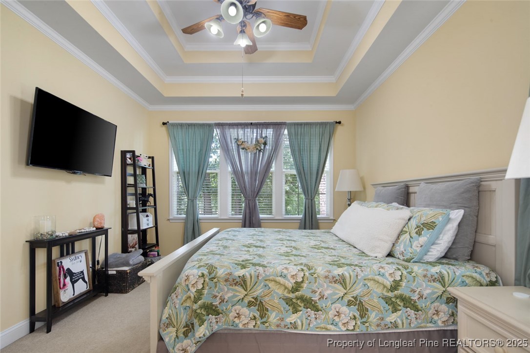 15 London Way Spring Lake, NC 28390 - Photo 27 of 46 a bedroom with a large bed and a flat tv screen on dresser