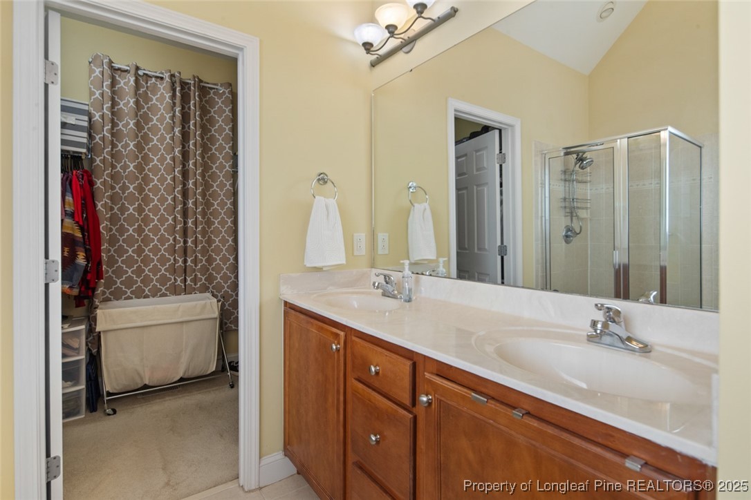 15 London Way Spring Lake, NC 28390 - Photo 29 of 46 a bathroom with a double vanity sink mirror and toilet