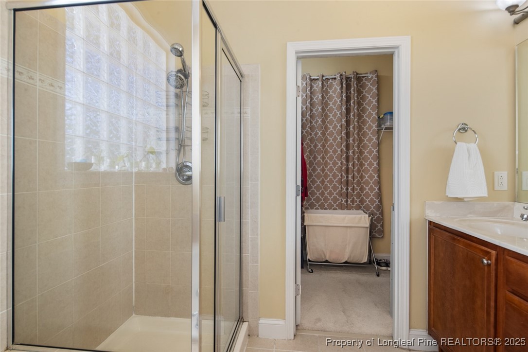 15 London Way Spring Lake, NC 28390 - Photo 31 of 46 a bathroom with a granite countertop sink a toilet and shower