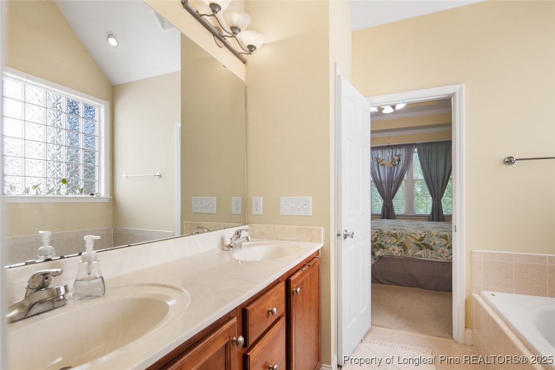 15 London Way Spring Lake, NC 28390 - Photo 32 of 46 a en suite bathroom with a sink double vanity and a mirror