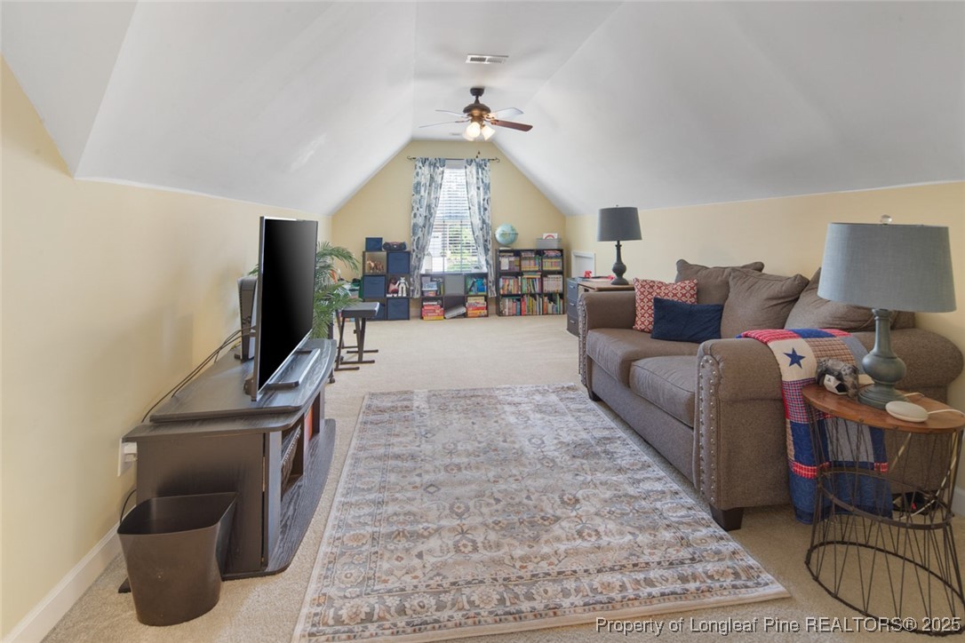 15 London Way Spring Lake, NC 28390 - Photo 33 of 46 a living room with furniture a flat screen tv and a table