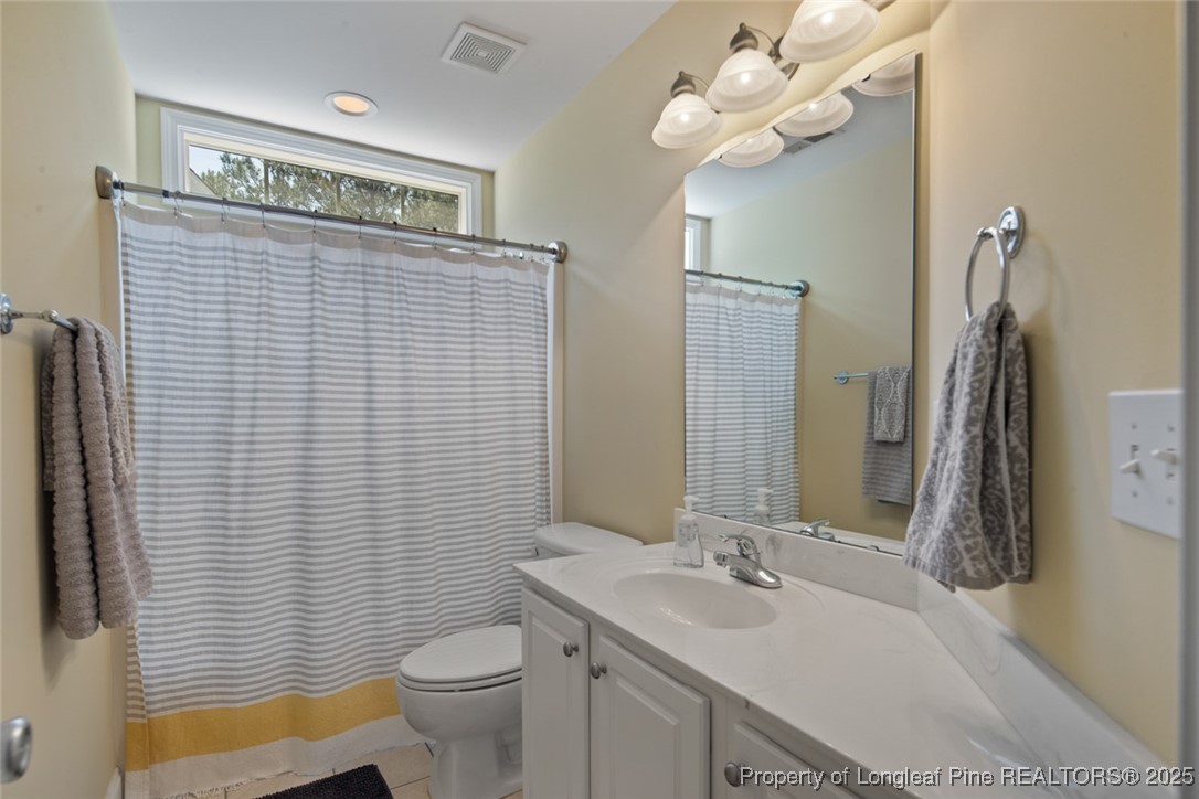 15 London Way Spring Lake, NC 28390 - Photo 35 of 46 a bathroom with a sink a toilet and a mirror