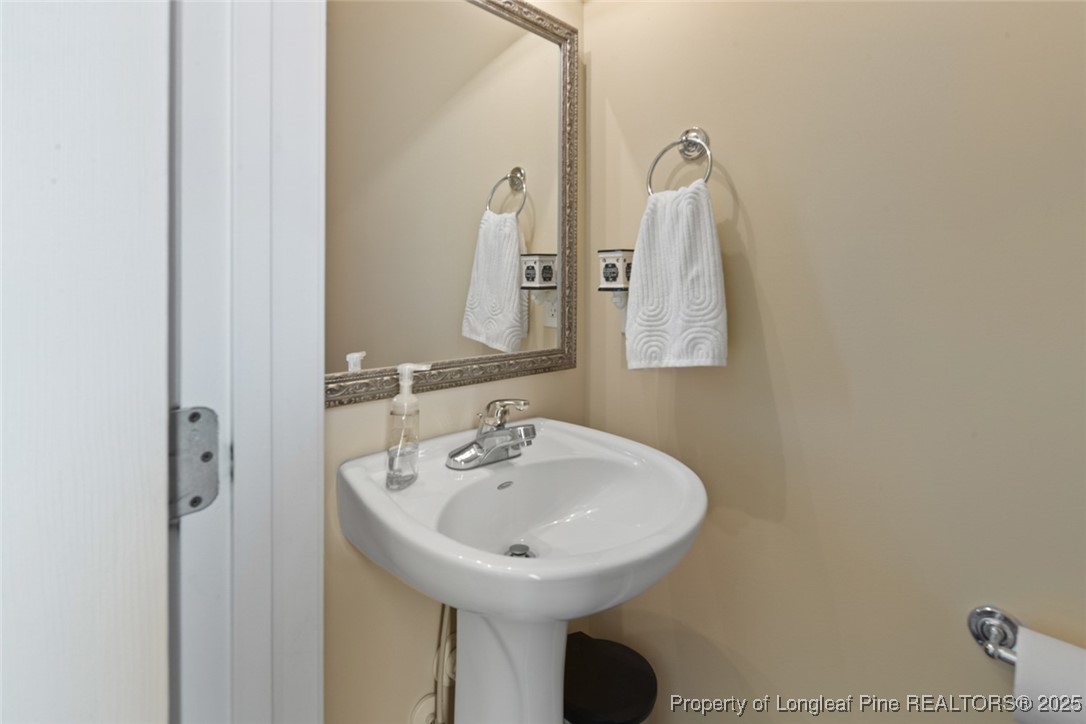 15 London Way Spring Lake, NC 28390 - Photo 10 of 46 a bathroom with a sink and a mirror