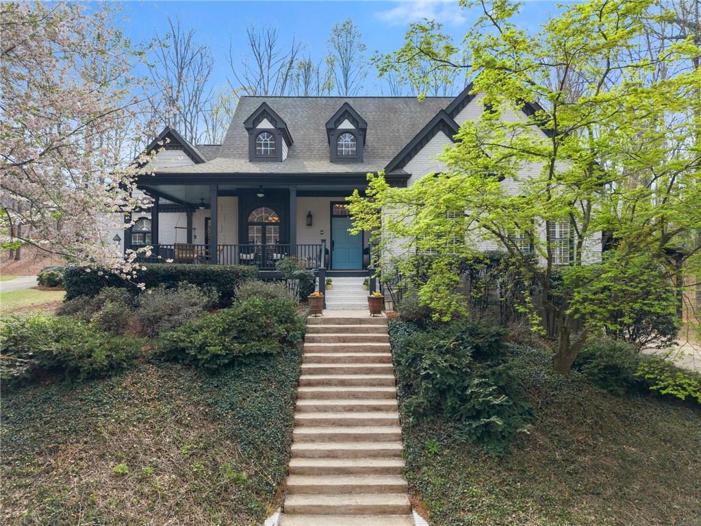 a front view of a house with a yard and potted plants