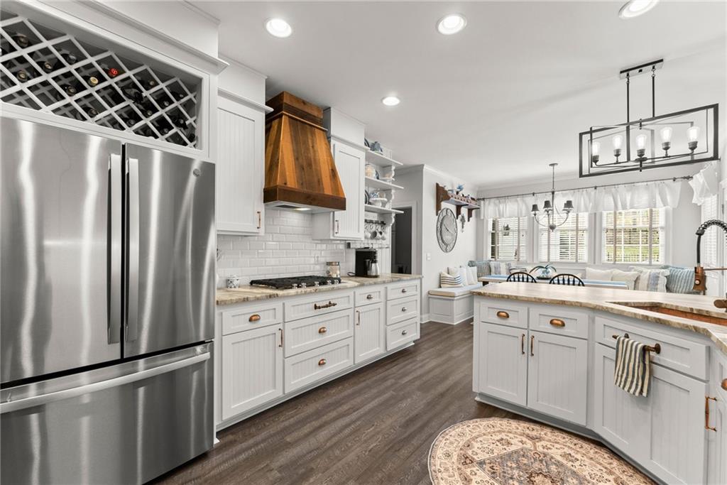 2195 East Maddox Road Buford, GA 30519 - Photo 14 of 100 a kitchen with stainless steel appliances granite countertop a stove a sink dishwasher a refrigerator and white cabinets with wooden floor