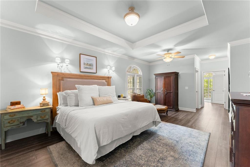 2195 East Maddox Road Buford, GA 30519 - Photo 18 of 100 a bedroom with a large bed and a chandelier