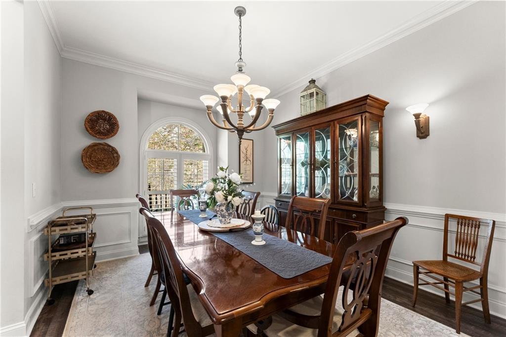 2195 East Maddox Road Buford, GA 30519 - Photo 29 of 100 a view of a dining room with furniture a chandelier and wooden floor