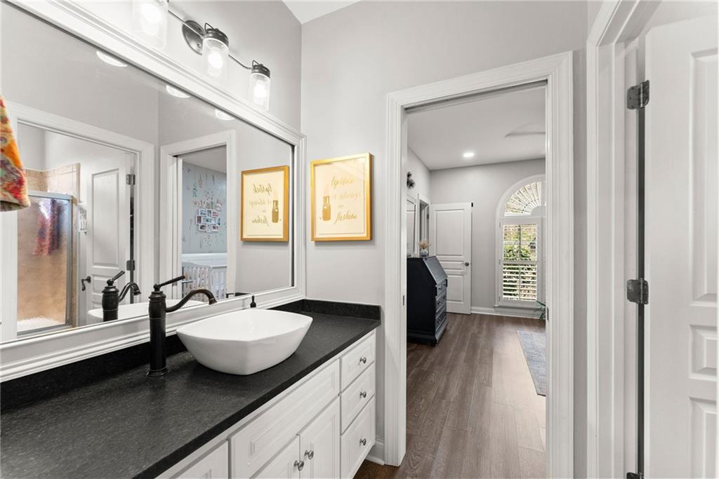 2195 East Maddox Road Buford, GA 30519 - Photo 34 of 100 a spacious bathroom with a granite countertop sink mirror and a shower
