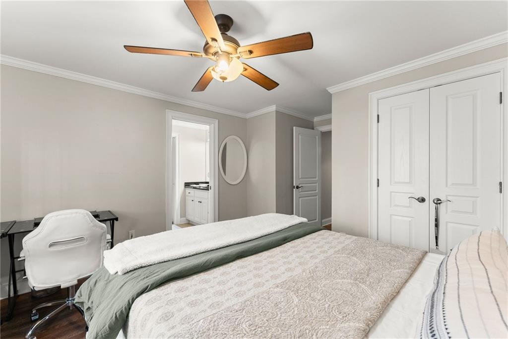 2195 East Maddox Road Buford, GA 30519 - Photo 55 of 100 a bedroom with a bed and a chandelier