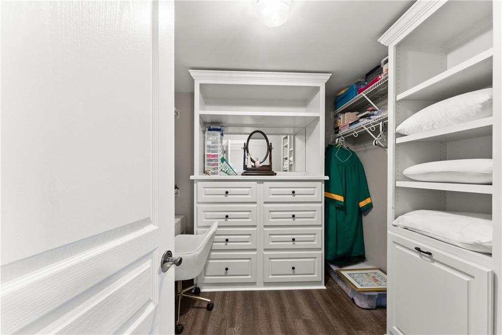 2195 East Maddox Road Buford, GA 30519 - Photo 60 of 100 a view of walk in closet with clothes and shoes