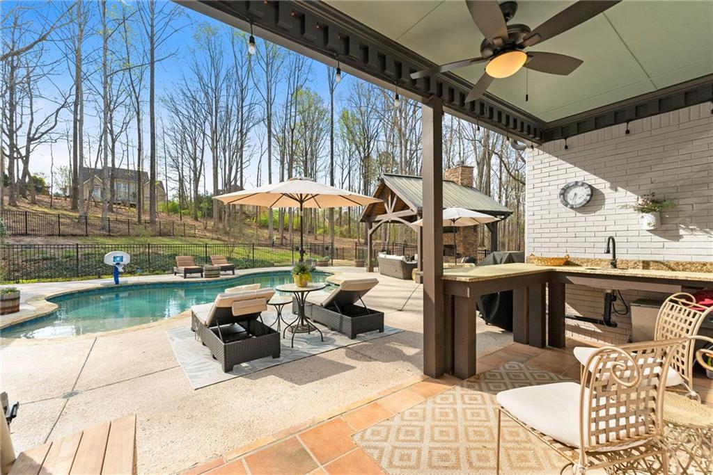 2195 East Maddox Road Buford, GA 30519 - Photo 66 of 100 a view of a patio with a table and chairs
