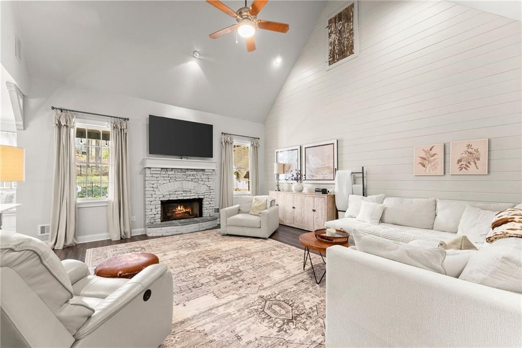 2195 East Maddox Road Buford, GA 30519 - Photo 7 of 100 a living room with furniture a fireplace and a flat screen tv