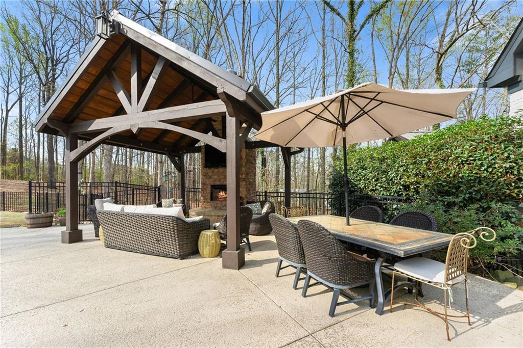 2195 East Maddox Road Buford, GA 30519 - Photo 71 of 100 a patio with a patio table and chairs