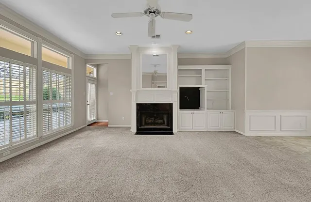 a view of empty room with fireplace and windows