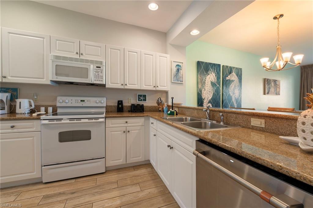 7940 Mahogany Run Lane, Unit 612 Naples, FL 34113 - Photo 16 of 25 a kitchen with a sink stove and cabinets