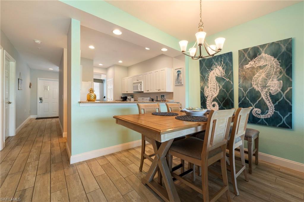 7940 Mahogany Run Lane, Unit 612 Naples, FL 34113 - Photo 17 of 25 a view of a dining room with furniture and wooden floor