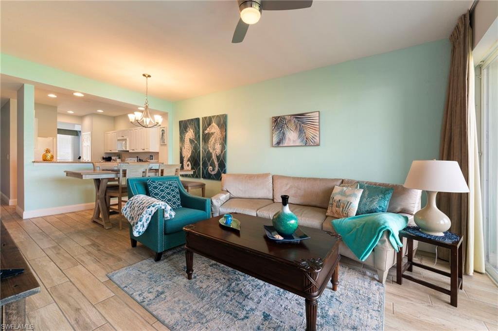 7940 Mahogany Run Lane, Unit 612 Naples, FL 34113 - Photo 19 of 25 a living room with furniture and a table