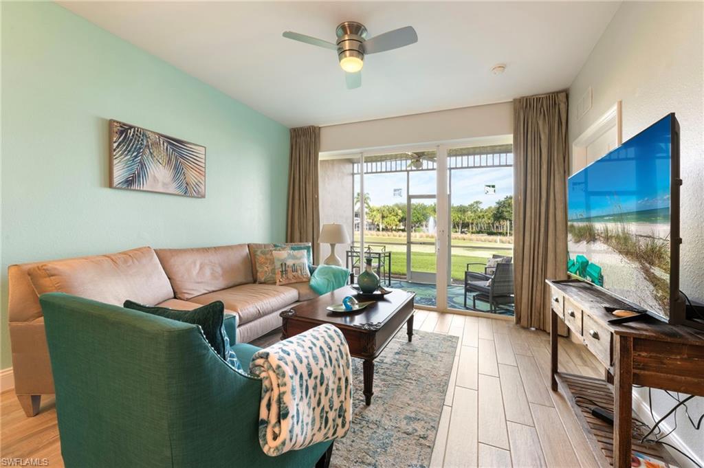 7940 Mahogany Run Lane, Unit 612 Naples, FL 34113 - Photo 20 of 25 a living room with furniture and a flat screen tv