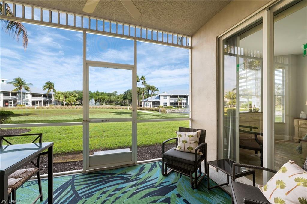 7940 Mahogany Run Lane, Unit 612 Naples, FL 34113 - Photo 2 of 25 a balcony with a table and chairs