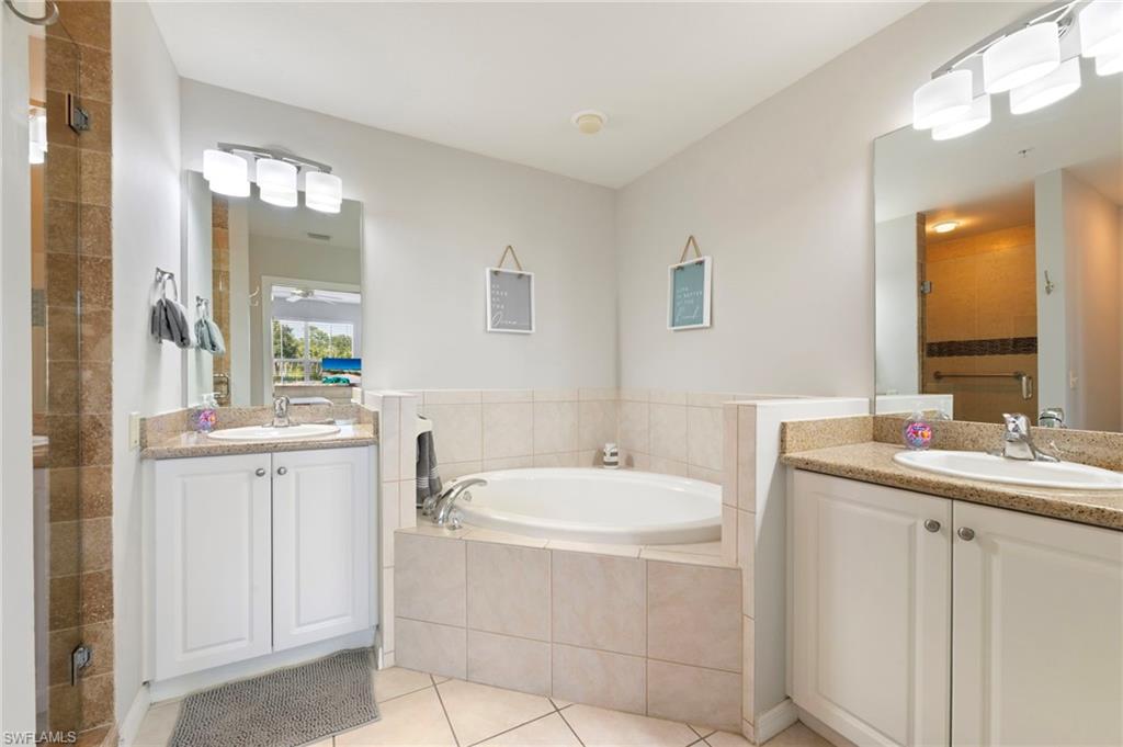 7940 Mahogany Run Lane, Unit 612 Naples, FL 34113 - Photo 8 of 25 a bathroom with a sink and a mirror