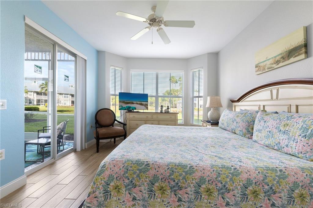 7940 Mahogany Run Lane, Unit 612 Naples, FL 34113 - Photo 9 of 25 a bedroom with a bed wooden floor and window
