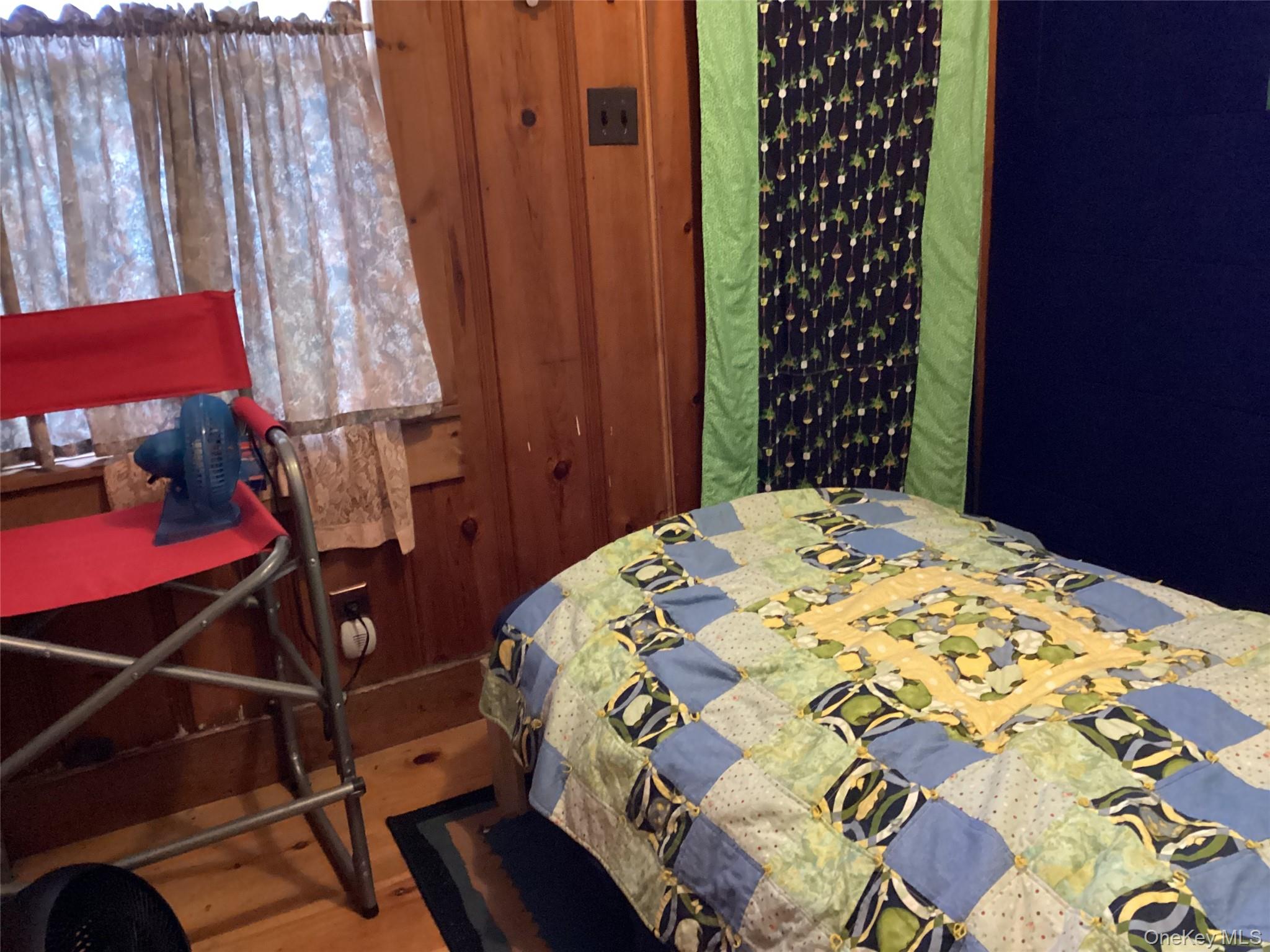 302 Todd Road, Unit T Woodbourne, NY 12788 - Photo 13 of 14 a bedroom with a bed and a chair