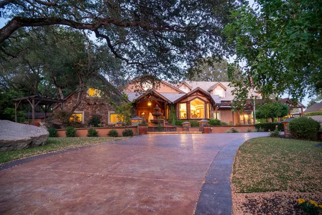 a view of a house with backyard porch and sitting area