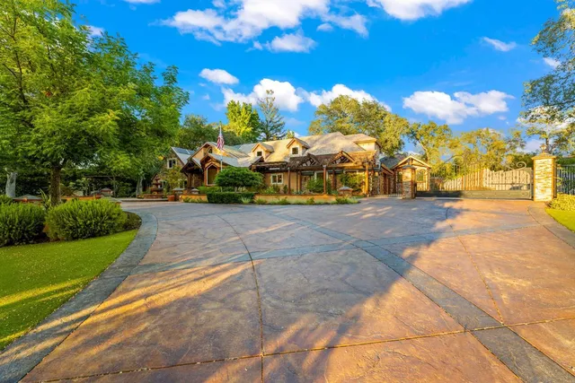 a kitchen with stainless steel appliances granite countertop a sink a stove and a wooden floors