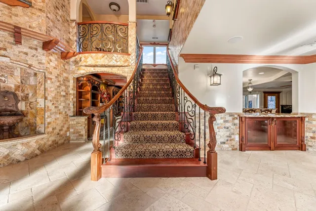 a kitchen with stainless steel appliances granite countertop a sink and a stove