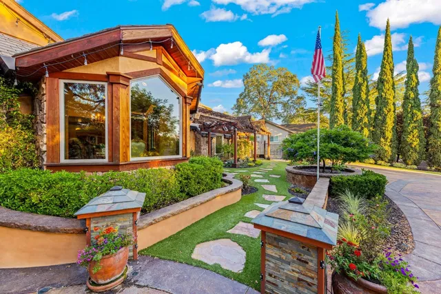 a kitchen with stainless steel appliances granite countertop a stove oven and a sink with cabinets