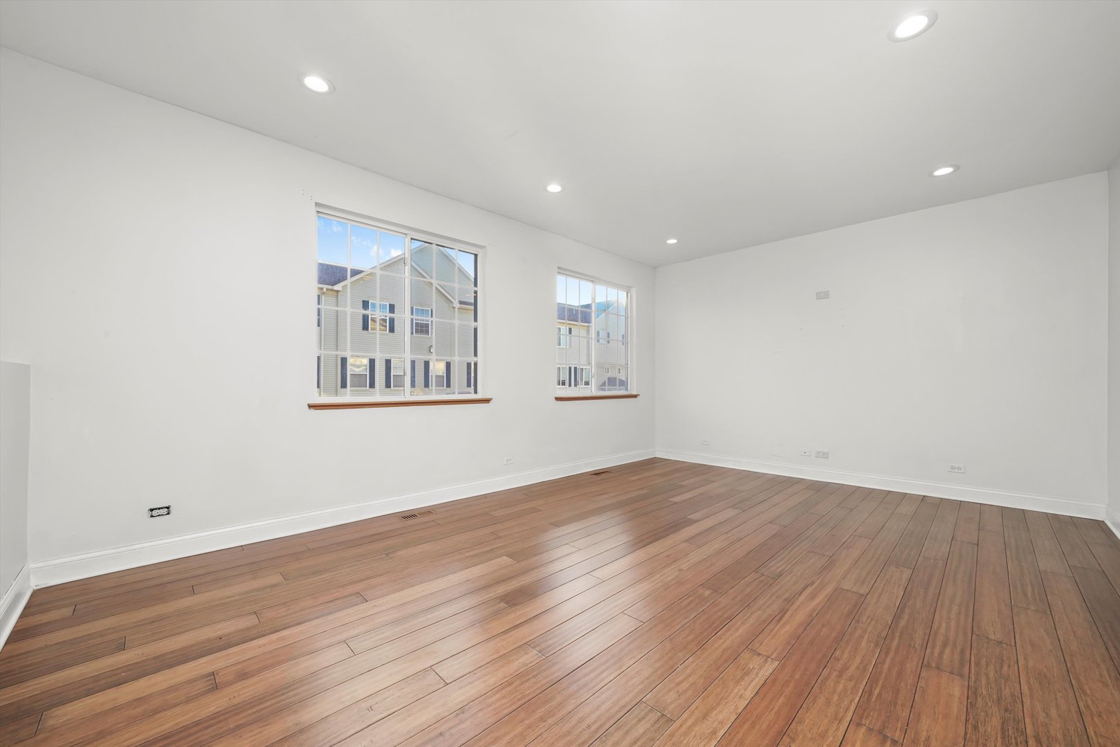 409 Evergreen Circle, Unit 4 Gilberts, IL 60136 - Photo 21 of 42 a view of an empty room with wooden floor and a window