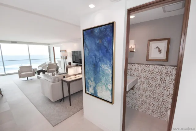 a dining room with stainless steel appliances kitchen island granite countertop a table chairs sink and wooden cabinets