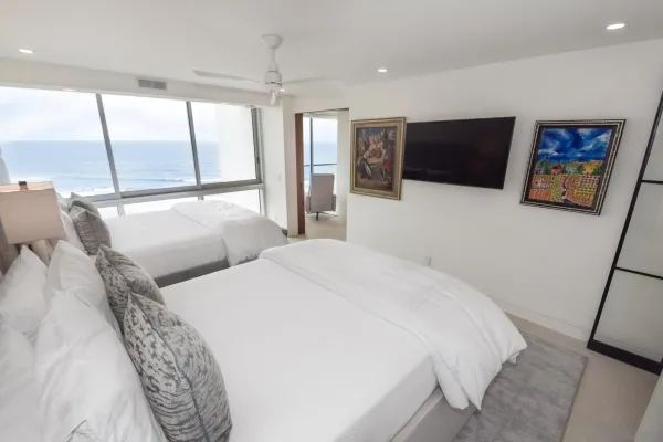 a bedroom with a bed and a flat screen tv