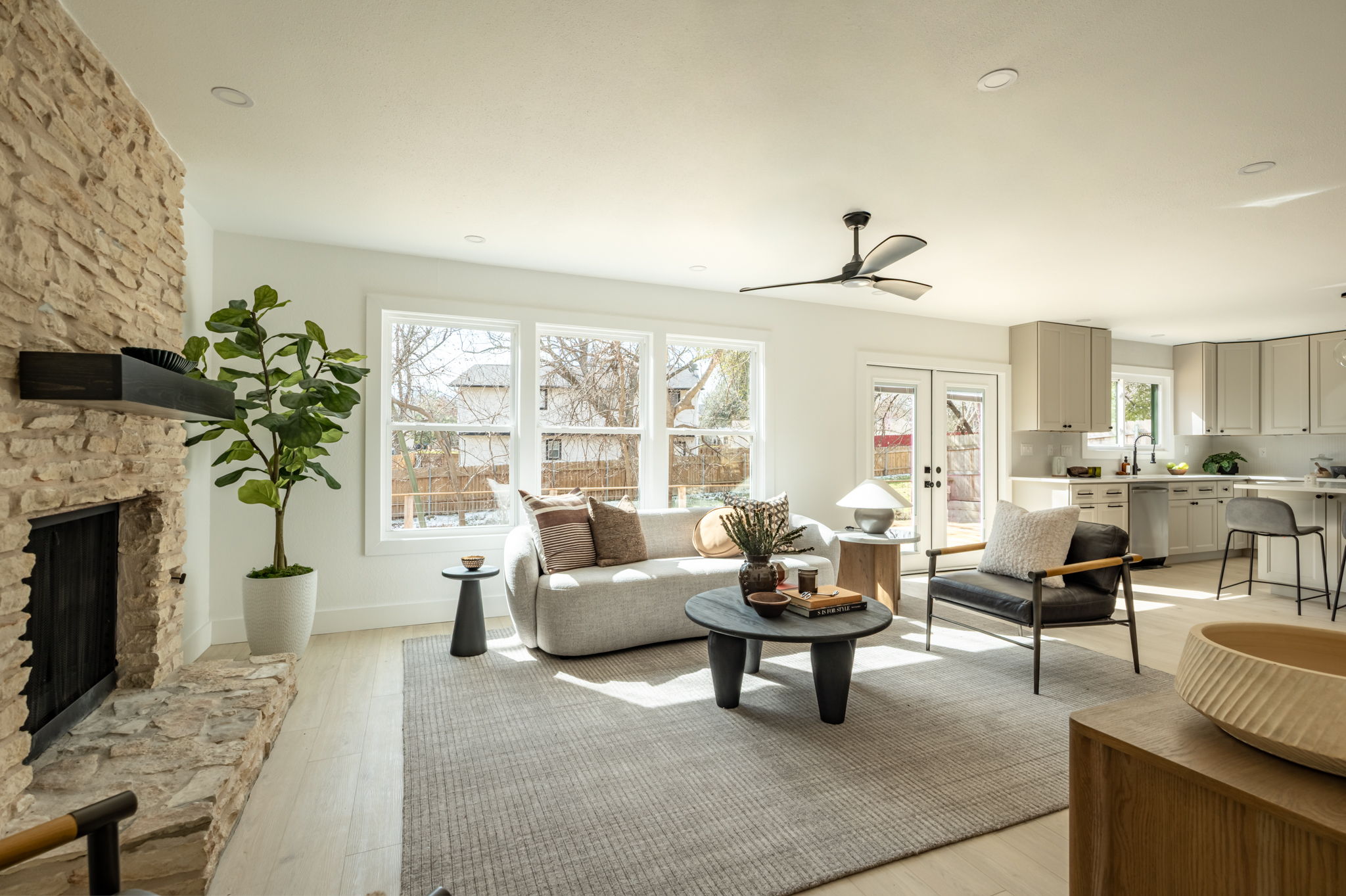 2201 Trede Drive Austin, TX 78745 - Photo 10 of 40 Living room with a stone fireplace, light wood-style flooring, french doors, a ceiling fan, and recessed lighting